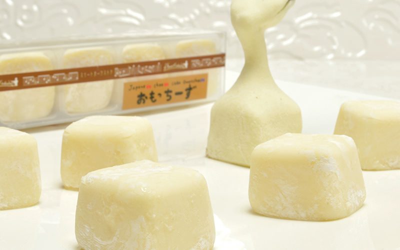 Cubed blocks of mochi spread out on a white background